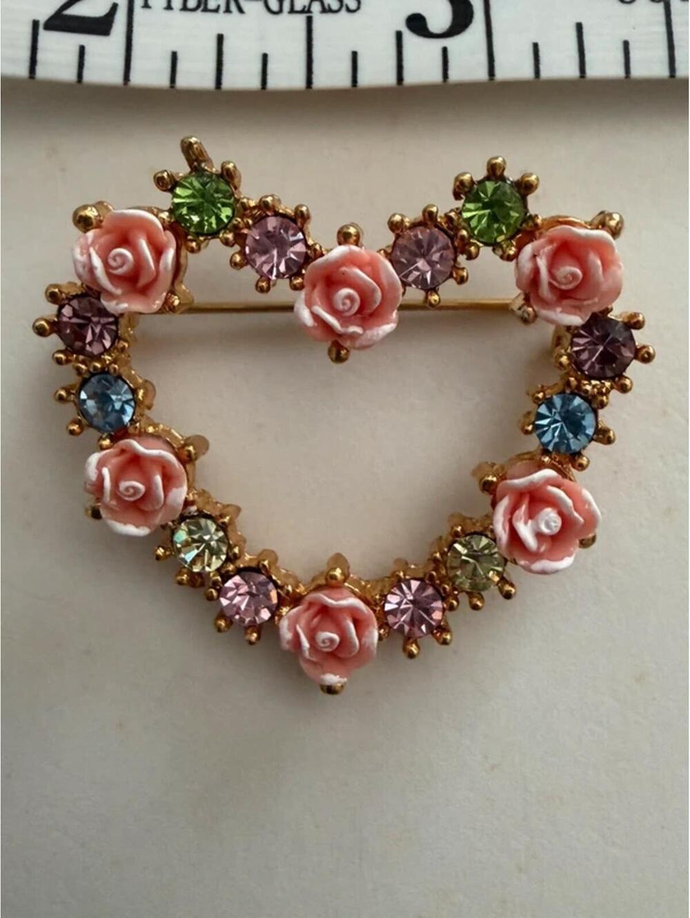 Avon heart brooch features molded pink roses and colorful rhinestones